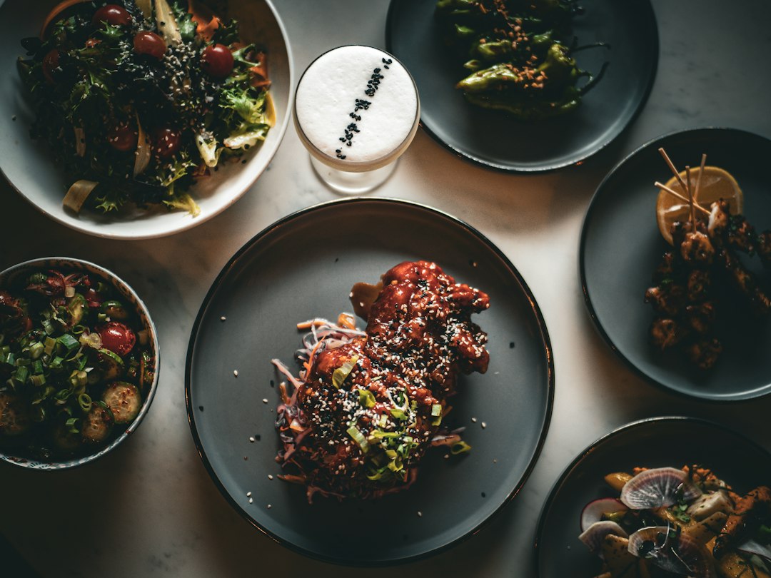 Variety of delicious dishes and a cocktail on a table