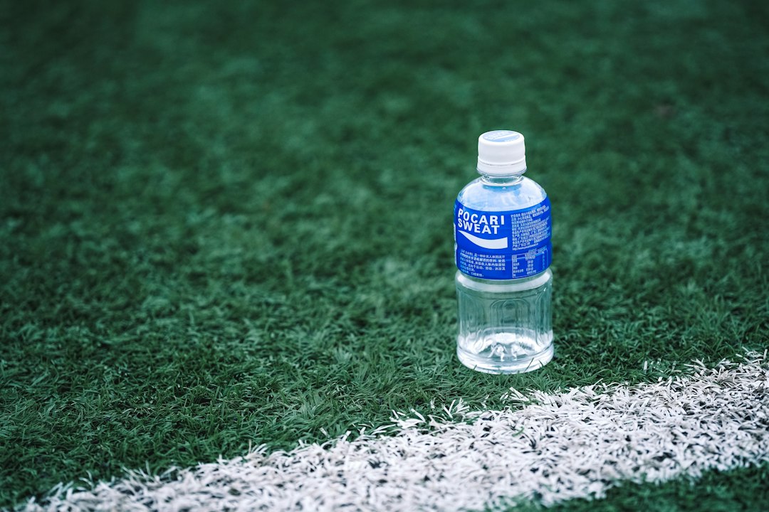 a bottle of water on a gravel surface