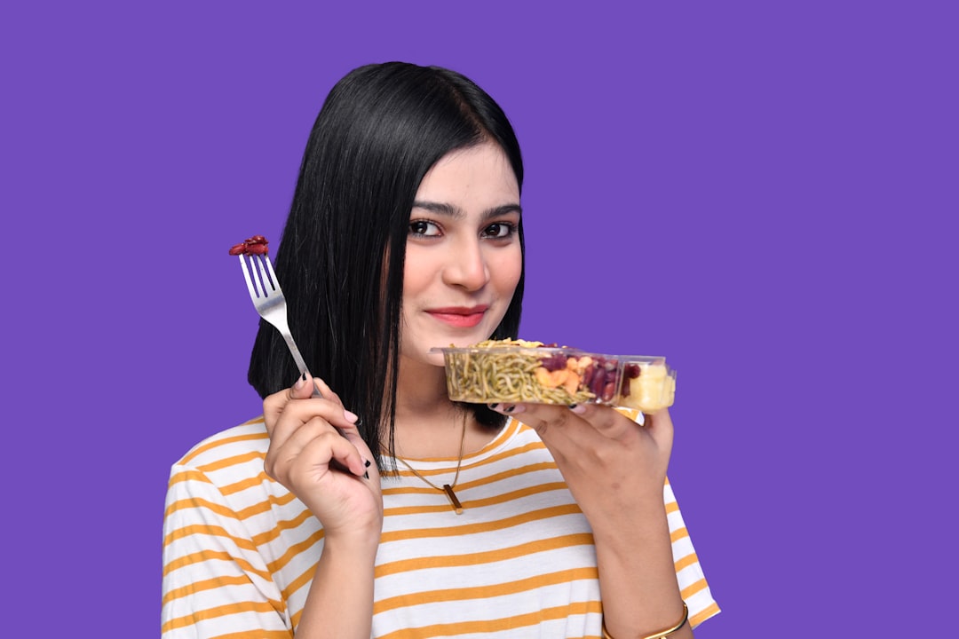 a woman holding a bowl of food
