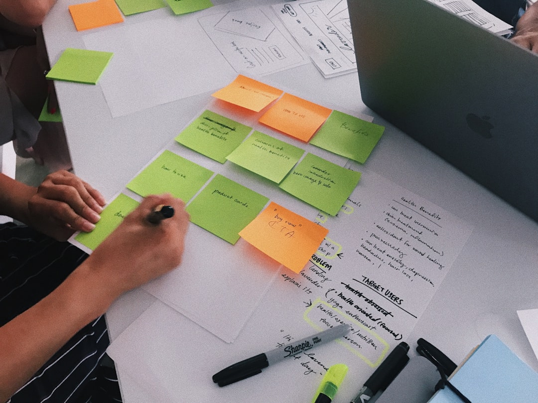 person writing on sticky notes