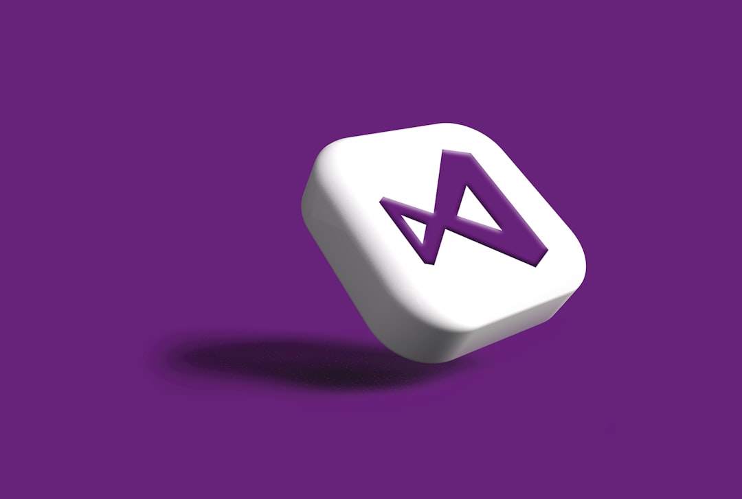 a white dice with a purple letter on it