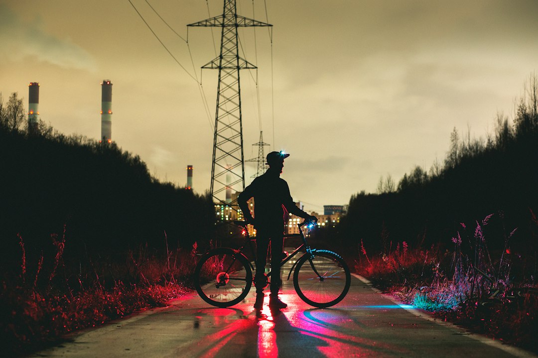 silhouette of man holding bike