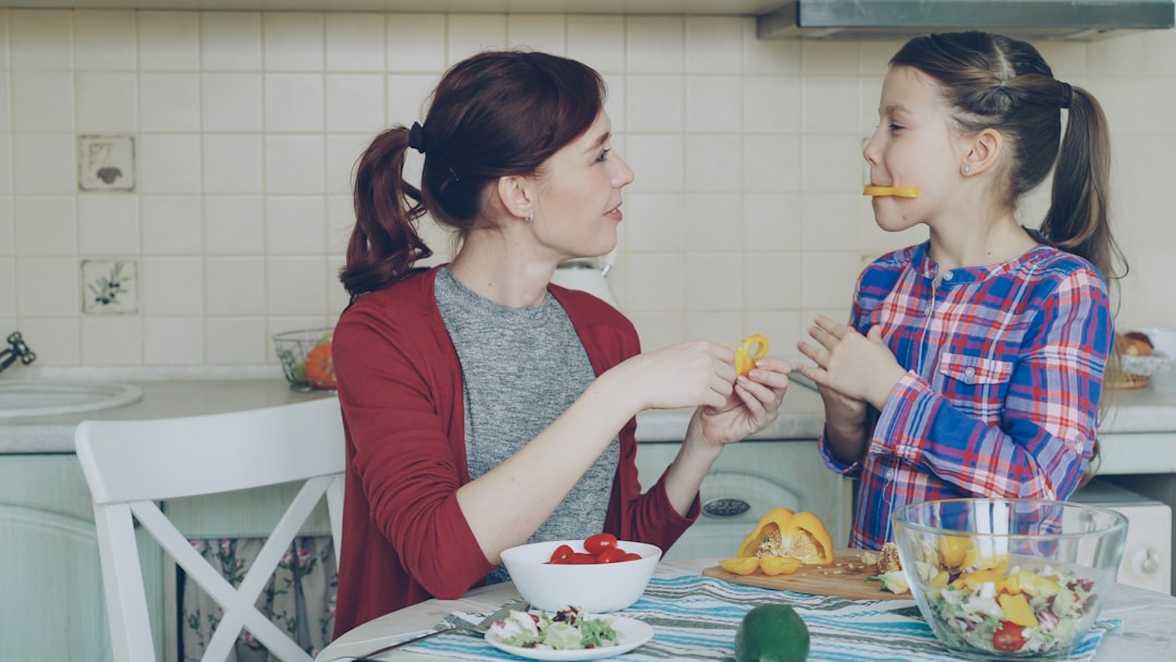 Mother and daughter enjoy snacks in the kitchen
