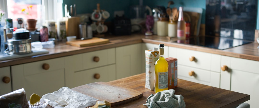 a kitchen counter with a few bottles of liquid on it