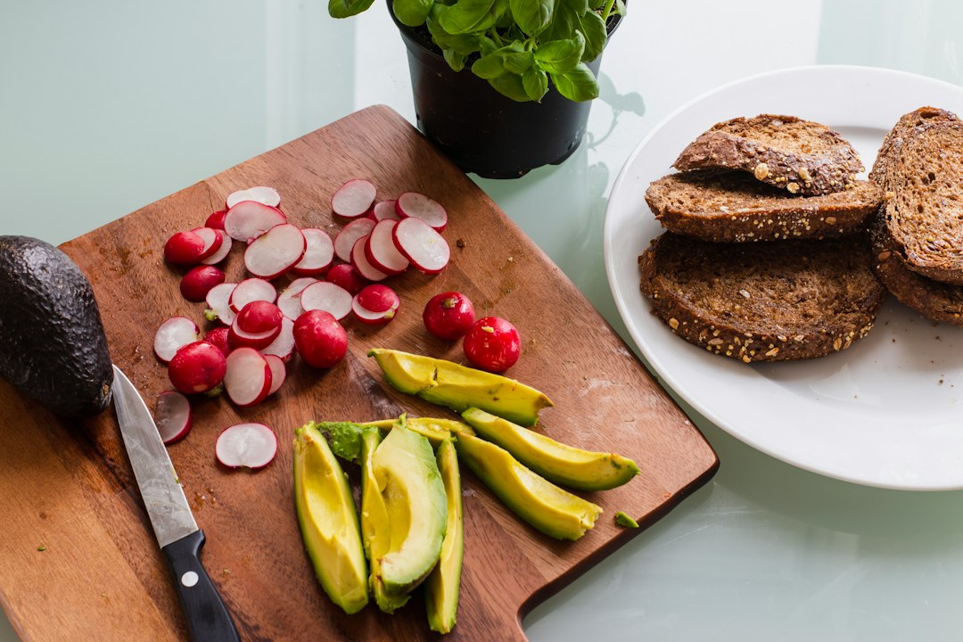 banana fruit and bread on brown wooden chopping board