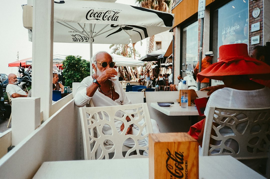 Man drinking coffee at outdoor cafe table