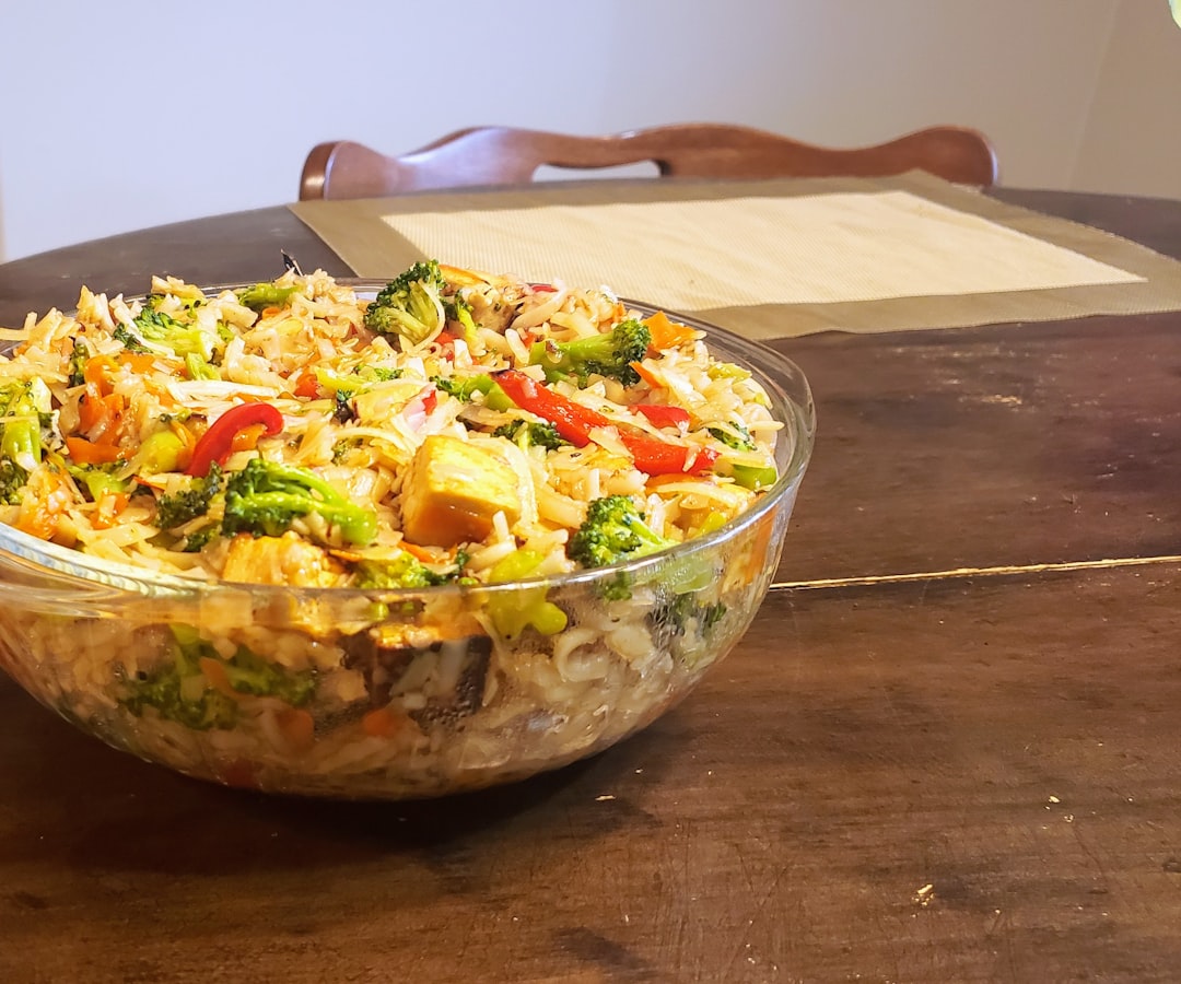 A bowl of food sitting on top of a wooden table
