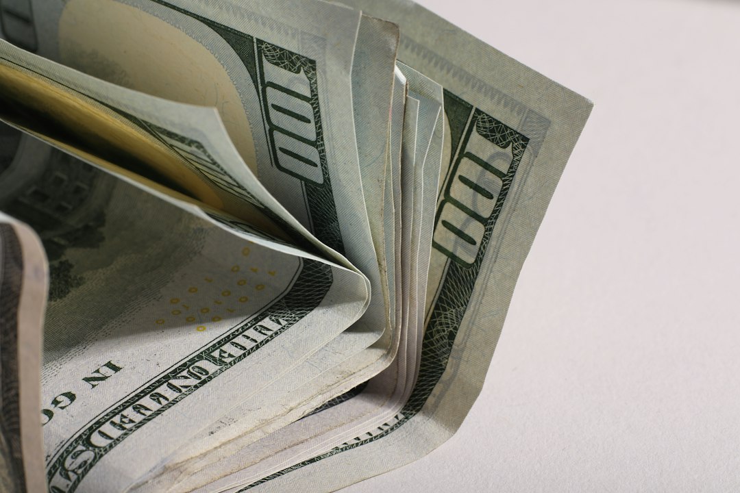 A close-up of a stack of us hundred dollar bills
