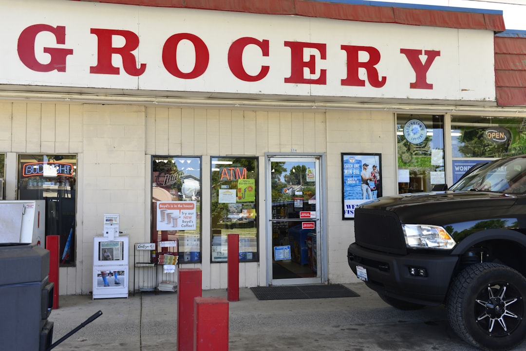 A truck parked in front of a grocery store