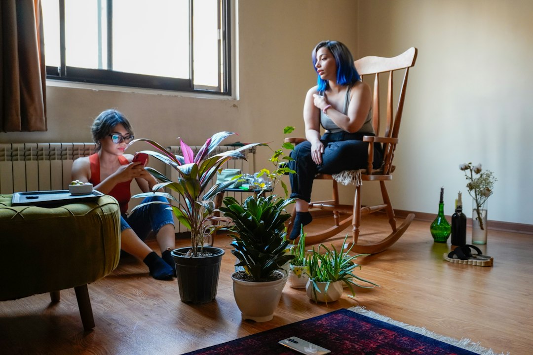 Two people relaxing in a room with plants