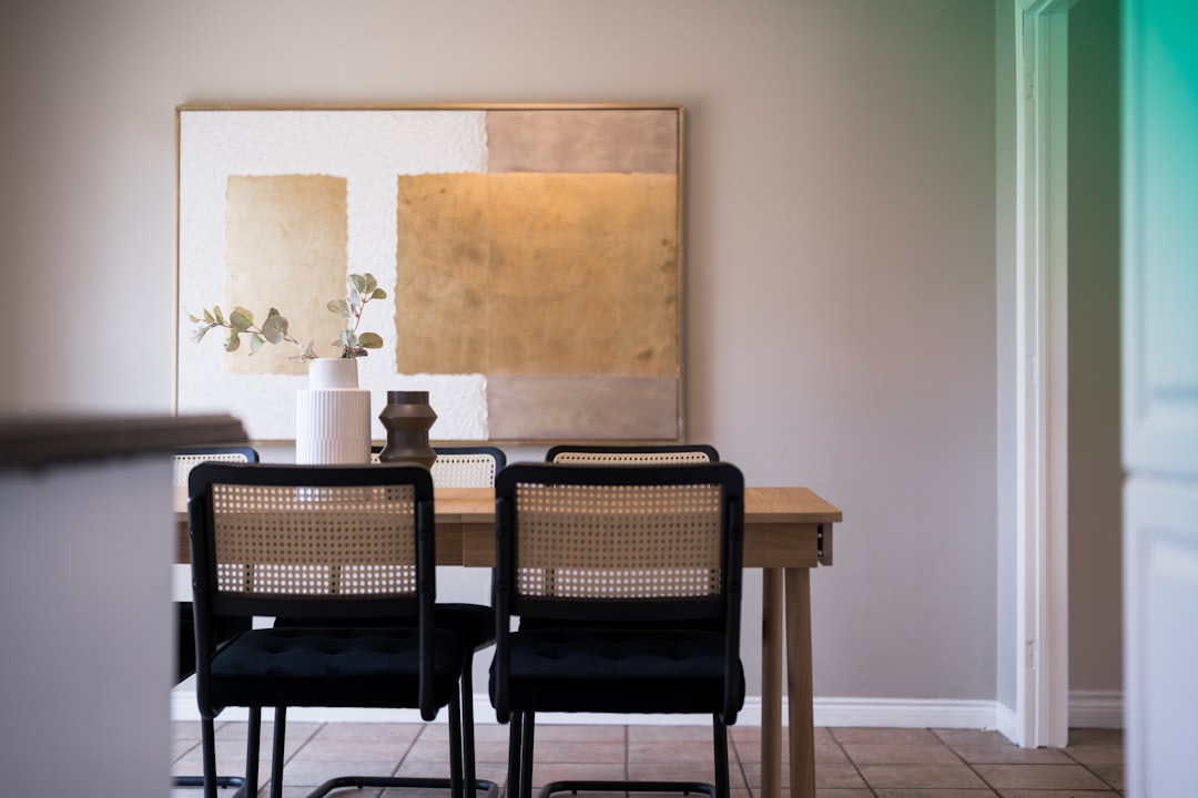 Dining table with chairs and artwork on wall art
