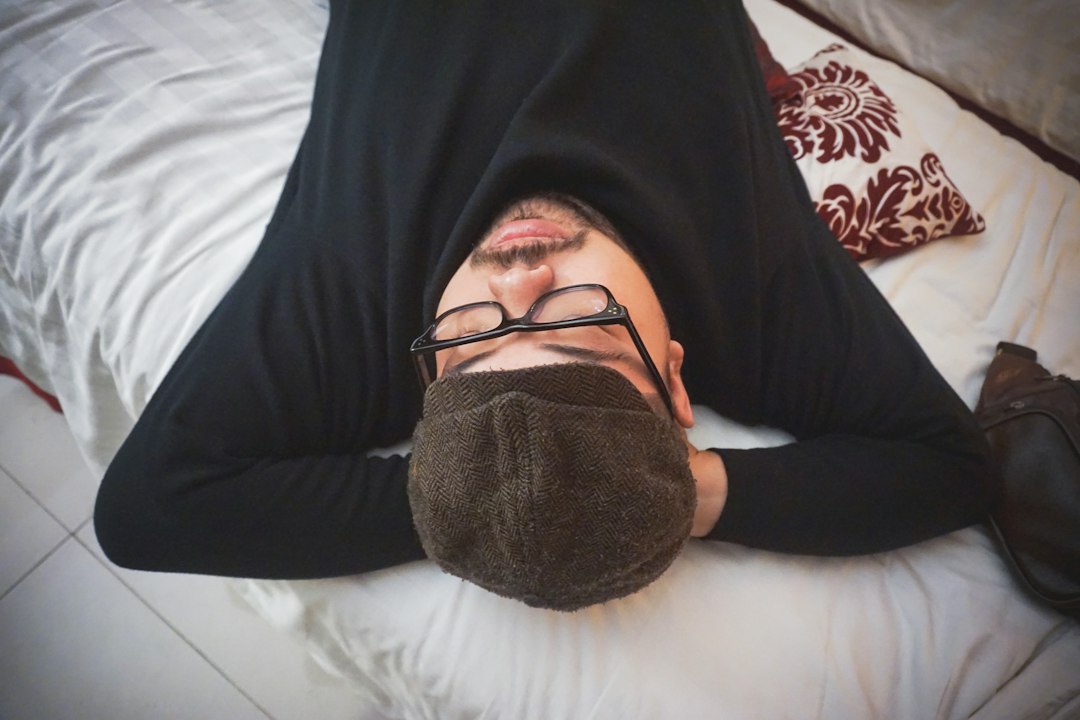 black framed eyeglasses on persons lap