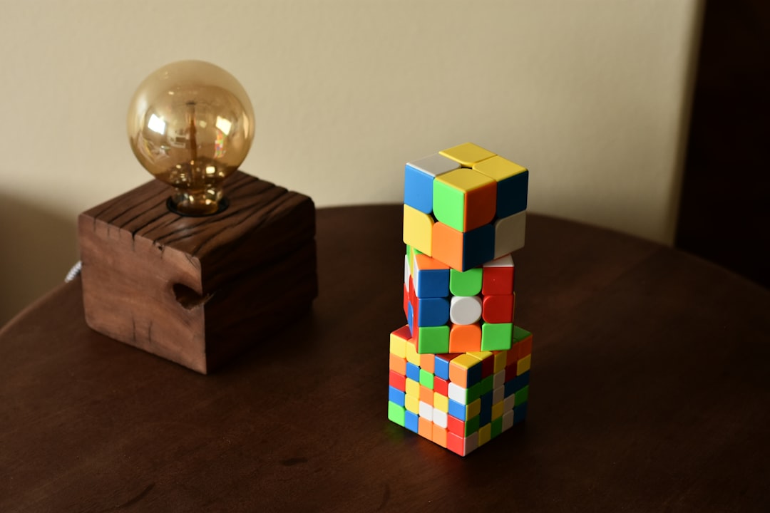 a wooden table topped with a wooden block and a golden ball