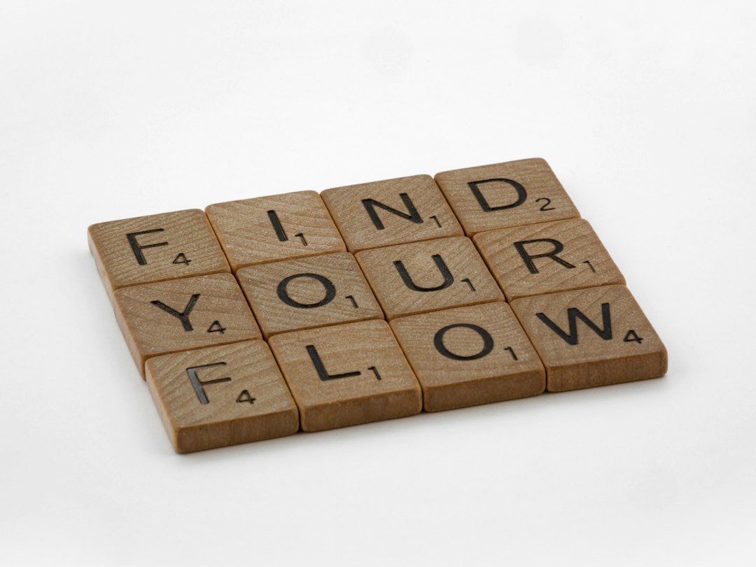 a scrabbled wooden block with the words find your flow on it