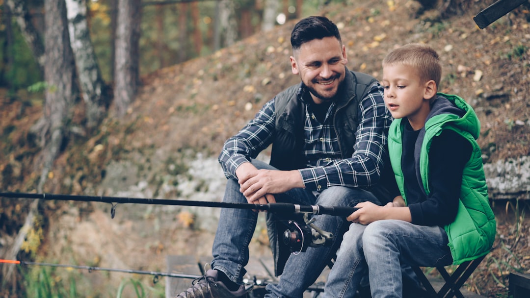 Father and son fishing together at a lake